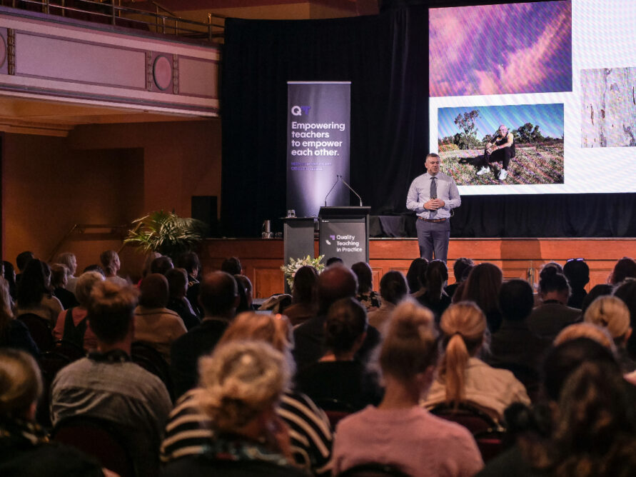 Nathan Towney on stage presenting his keynote.